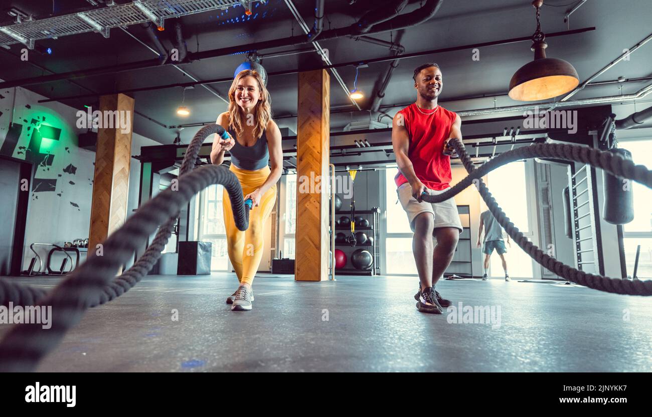 Functional training with battle rope in crossfit gym for better fitness Stock Photo