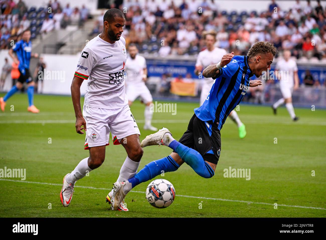 OHL's Dylan Ouedraogo and Club's Noa Lang fight for the ball during a
