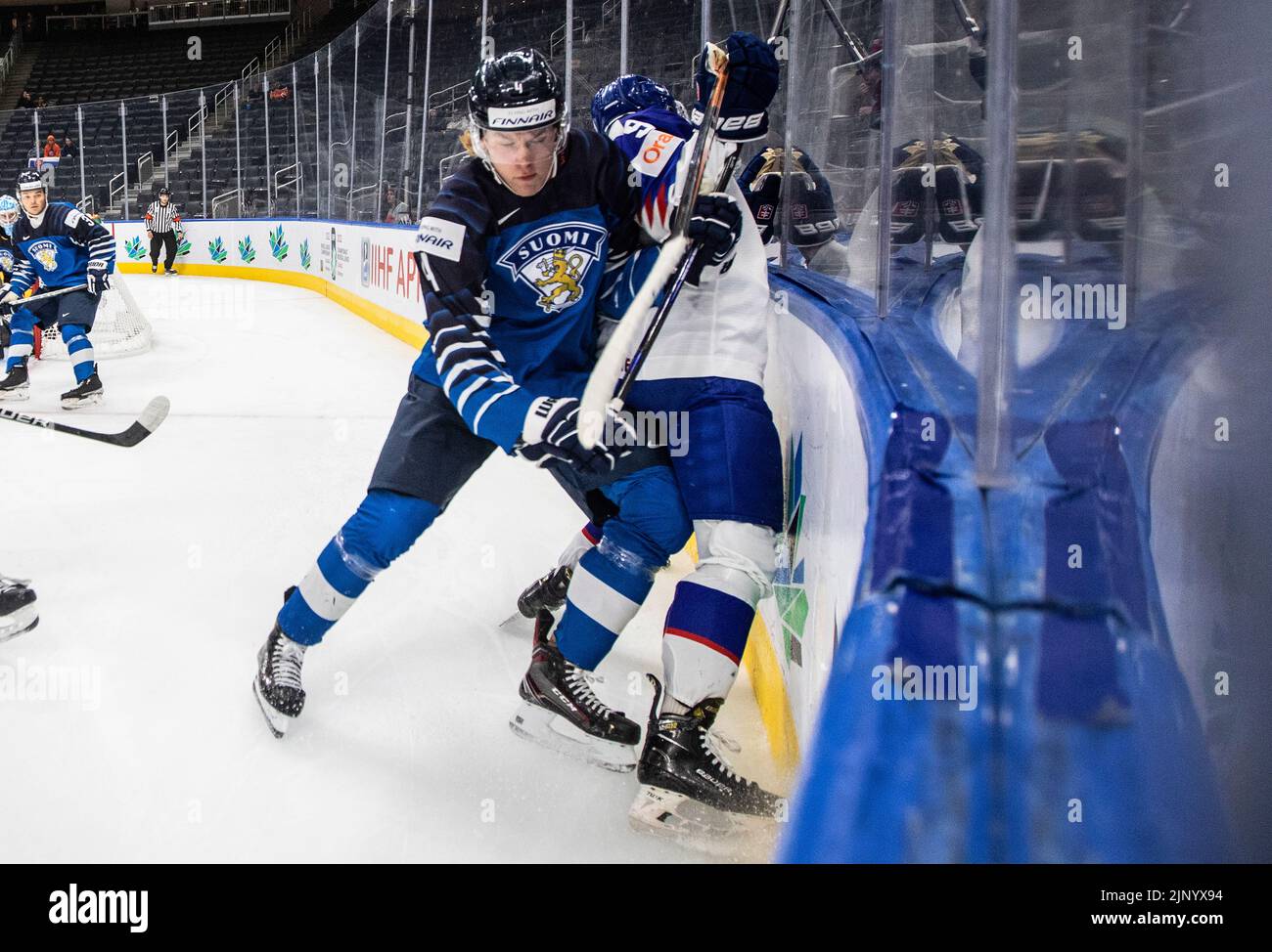 Finland's Joni Jurmo (4) checks Slovakia's Roman Faith (9) during third