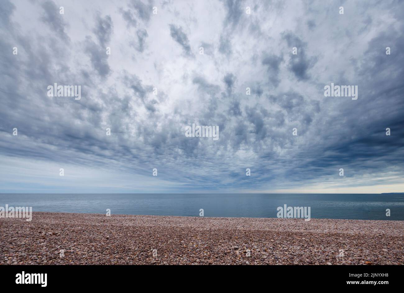 Wide angle (14mm at f/11) view of clouds over the sea horizon at Budleigh Salterton in East Devon on the Jurassic Coast (suitable for sky replacement) Stock Photo