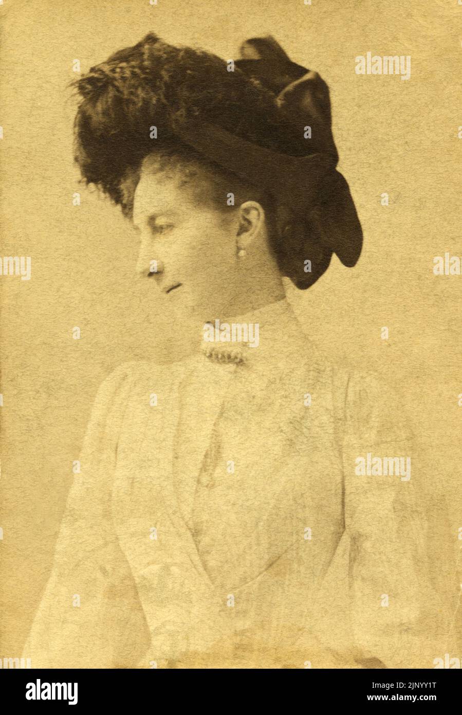 Late 19th Century Vintage Photograph Portrait of young woman in profile posing in photo studio wearing hat and stylish clothing of the period circa 1889 Budapest Stock Photo