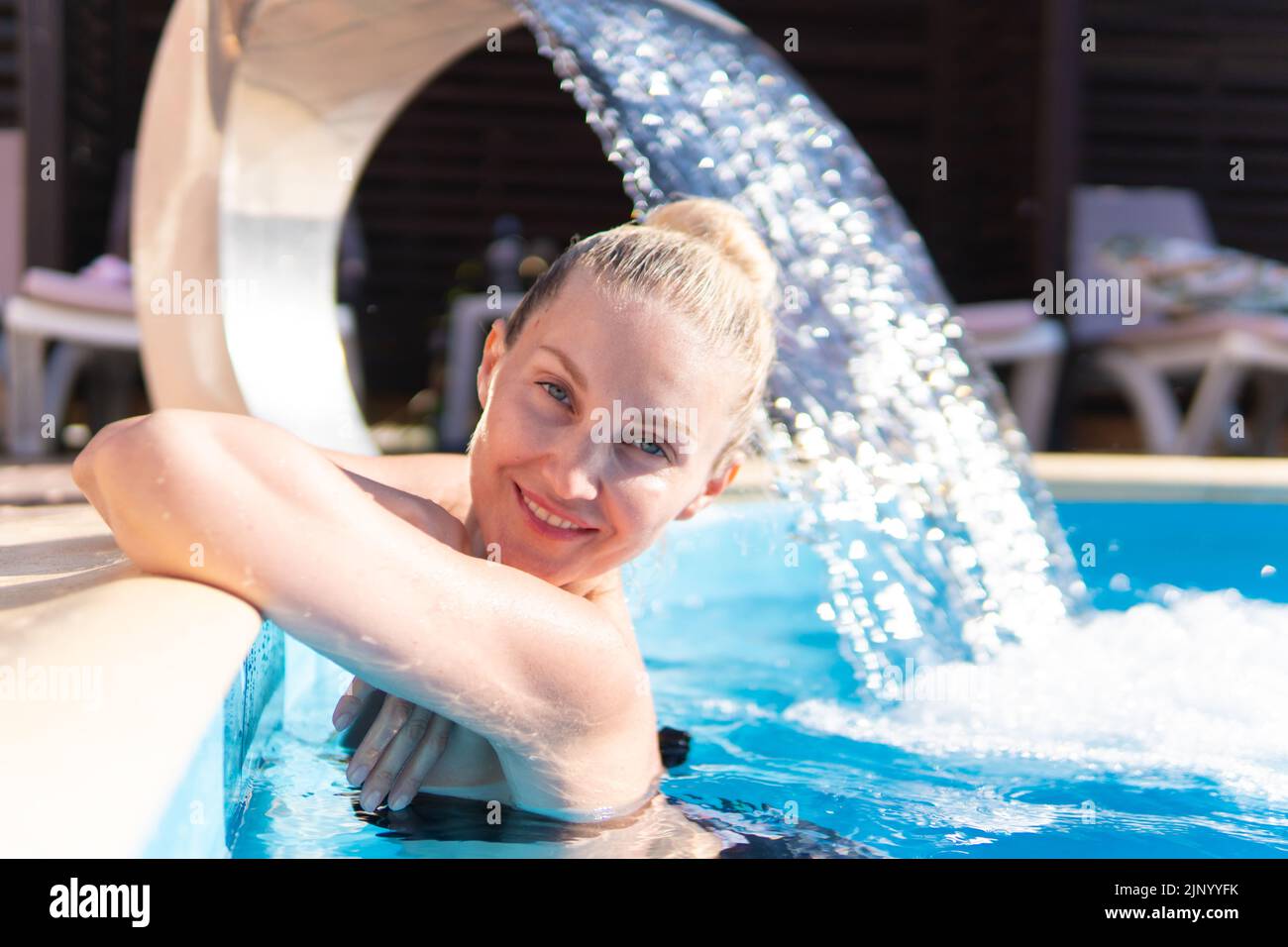 Smiling waterfall woman young swimming pool beautiful luxury model