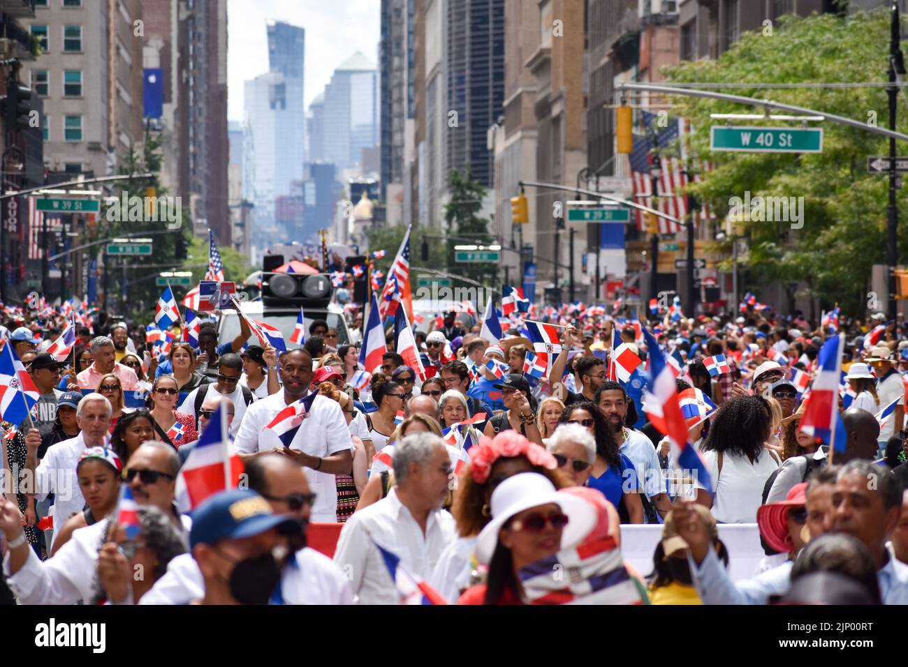 A group of people is marching along Sixth Avenue during the annual Dominican Day parade on August 14, 2022 in New York City. Stock Photo
