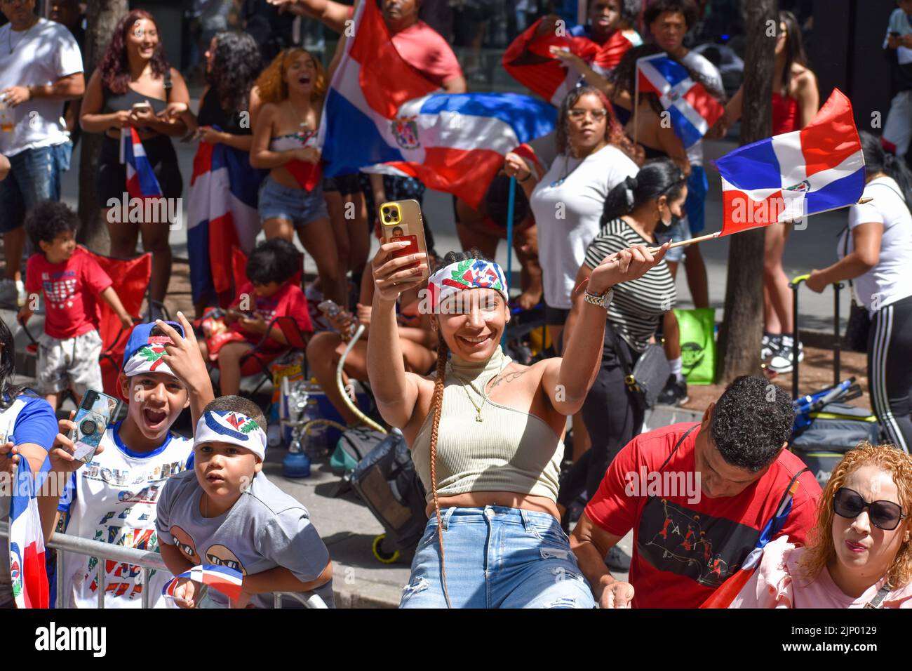 A participant is wearing dominican headband during the Dominican Day Parade on Sixth Avenue in New York City. Stock Photo