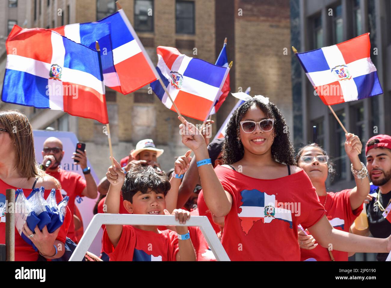 New Yorkers of all ages are seen on a float during the Dominican Day Parade on Sixth Avenue in New York City. Stock Photo