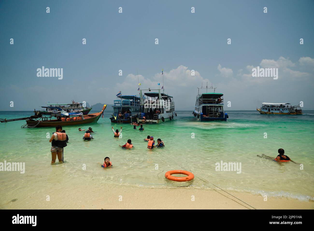 Beach on Koh Kradan Island in the Andaman Sea. Traditional Thai boats