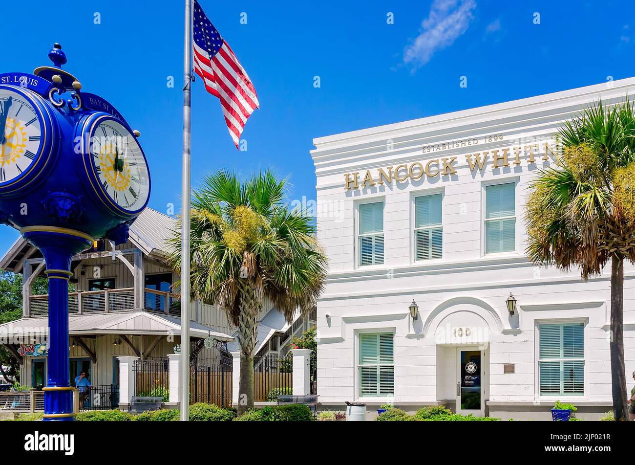 The Bay Saint Louis clock, a four-sided post clock, stands in front of Hancock Whitney Bank, Aug. 13, 2022, in Bay Saint Louis, Mississippi. Stock Photo