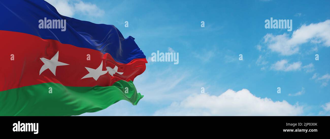 flag of Austroasiatic peoples Degar Montagnard at cloudy sky background, panoramic view.flag representing ethnic group or culture, regional authoritie Stock Photo