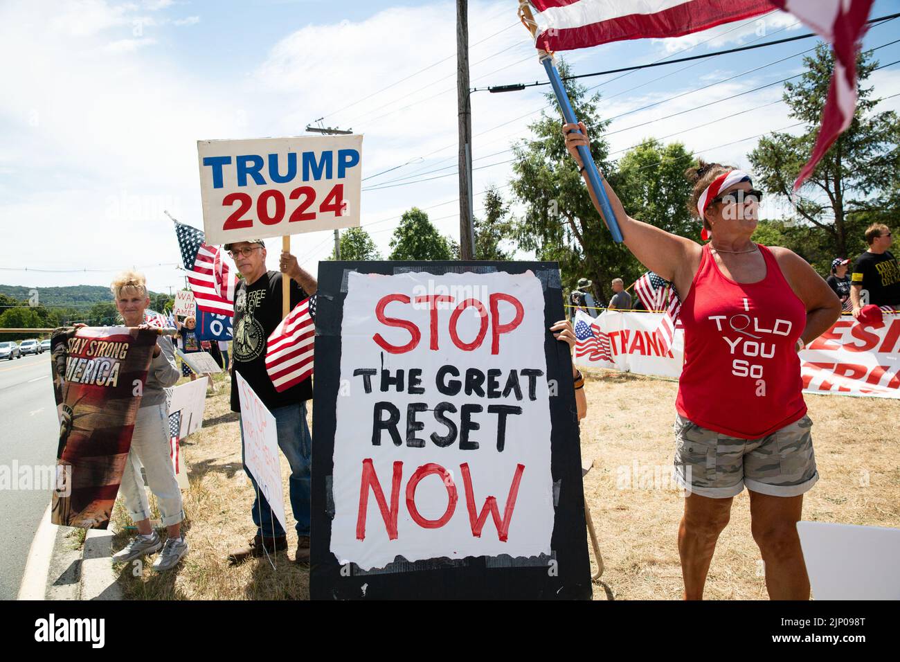 Bedminster, United States. 14th Aug, 2022. Protesters hold signs reading, 'Stop the great reset now' and 'Trump 20224' seen during the Trump supporters rally. Trump supporters rally at the corner of Lamington Road and Route 206 near the Trump National Golf Club in Bedminster, New Jersey. This comes following the FBI's raid on former President Donald Trump's Mar-A-Lago home. Credit: SOPA Images Limited/Alamy Live News Stock Photo