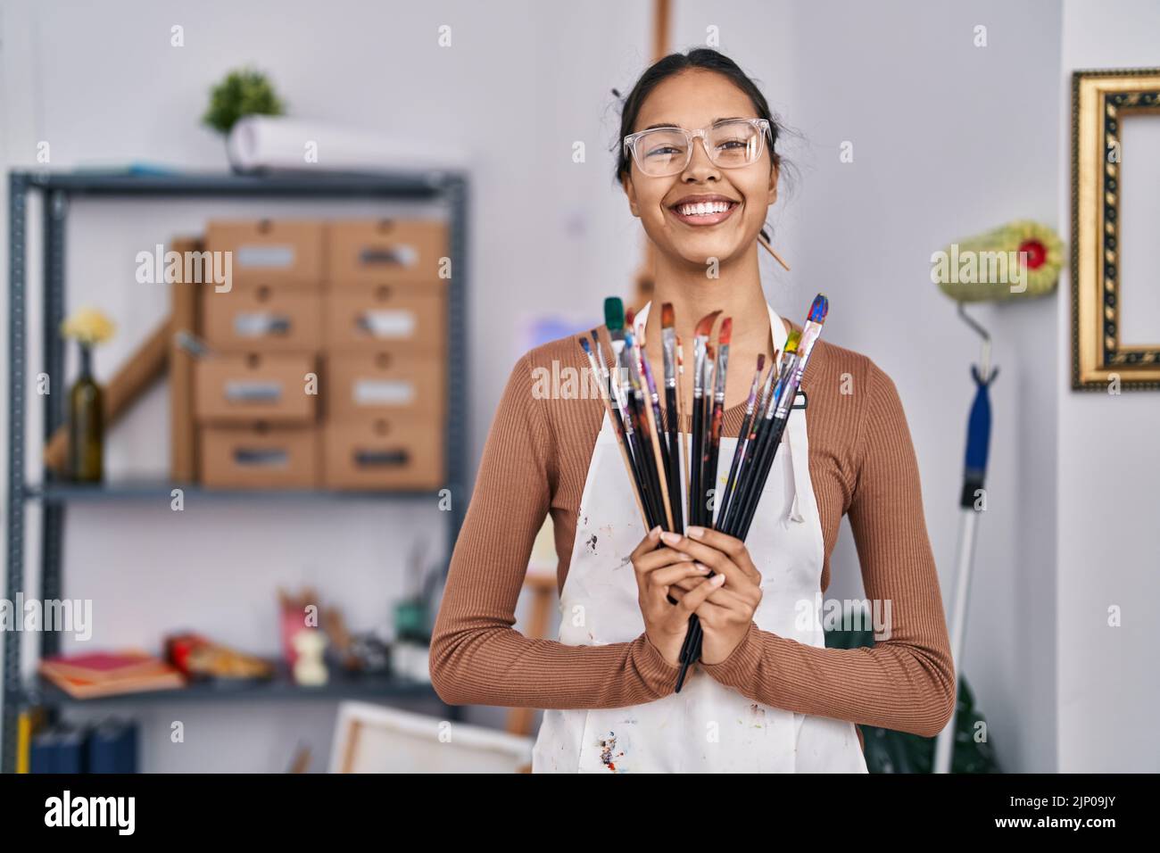 Young african american woman artist smiling confident holding ...