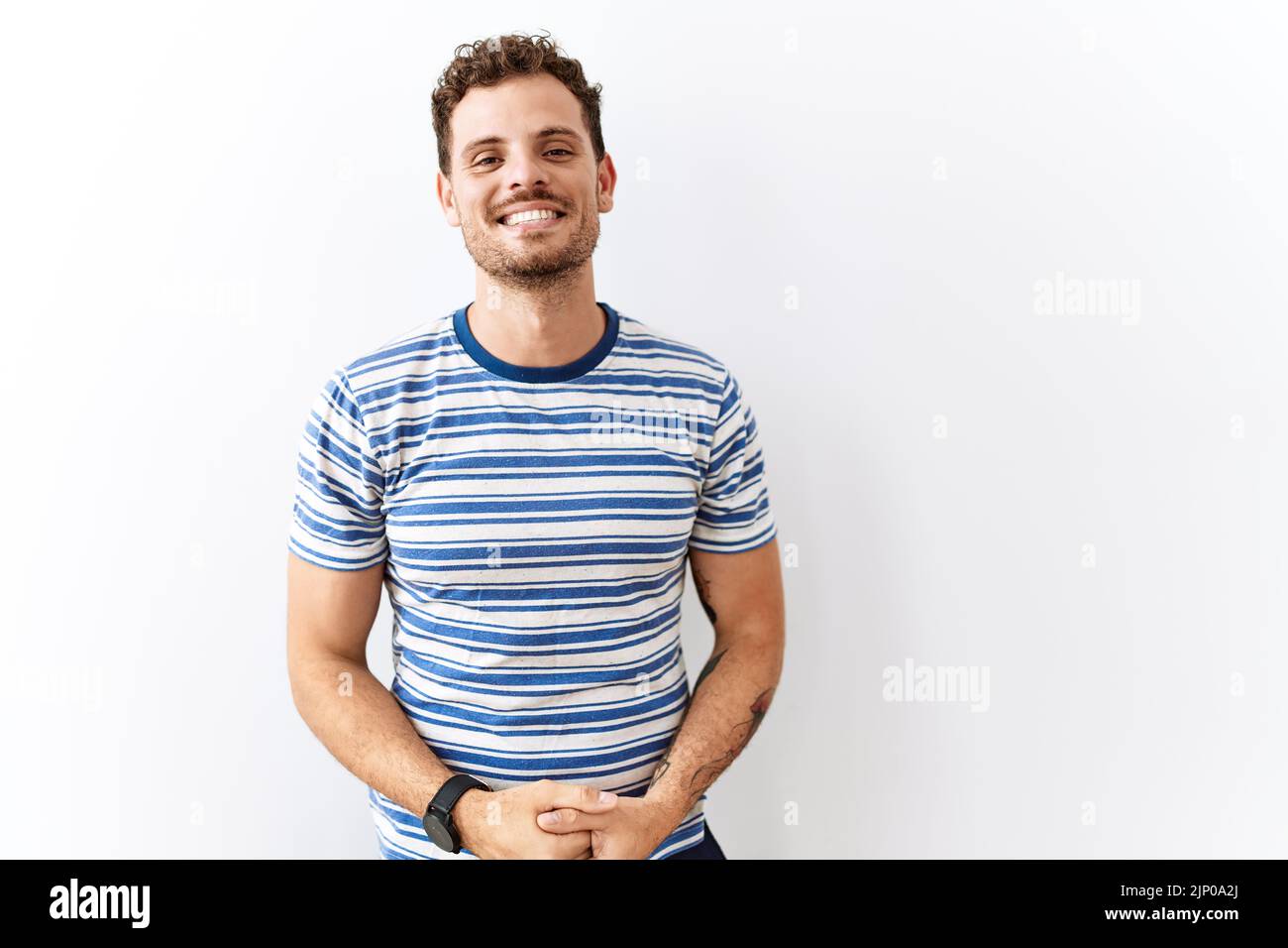 Handsome young man standing over isolated background with hands ...