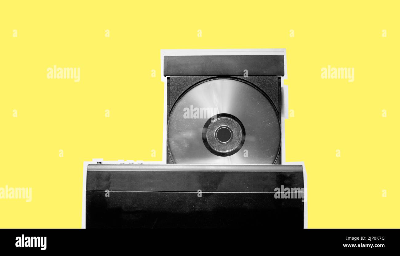 Black and white of dirty dvd player with disk isolated on yellow pastel