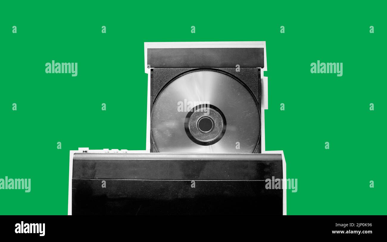 Close up view of dirty dvd player with disk isolated on green background Stock Photo