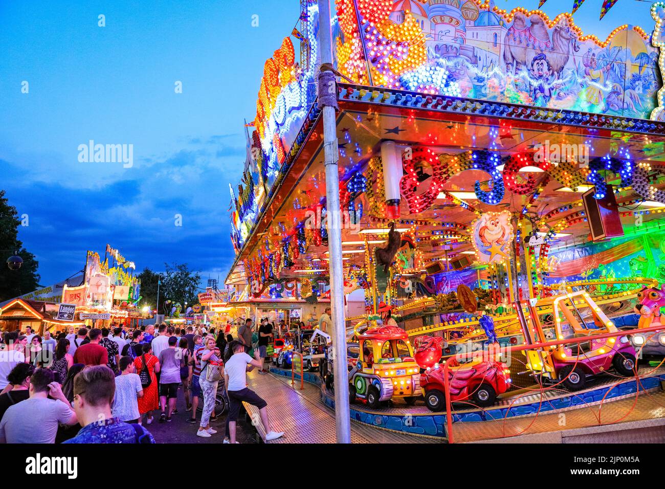 Herne, NRW, Germany. 14th Aug, 2022. The fair becomes more crowded towards the eve as temperatures drop slightly. Cranger Kirmes, Germany's 3rd largest funfair with a tradition dating back to the middle ages, has returned to pre-pandemic visitor numbers with more than 3.9m attending in hot, sunny weather, enjoying the rides, rollercoasters, beer halls, food and drink. The funfair concluded tonight with fireworks over the nearby Rhine-Herne Canal. Credit: Imageplotter/Alamy Live News Stock Photo