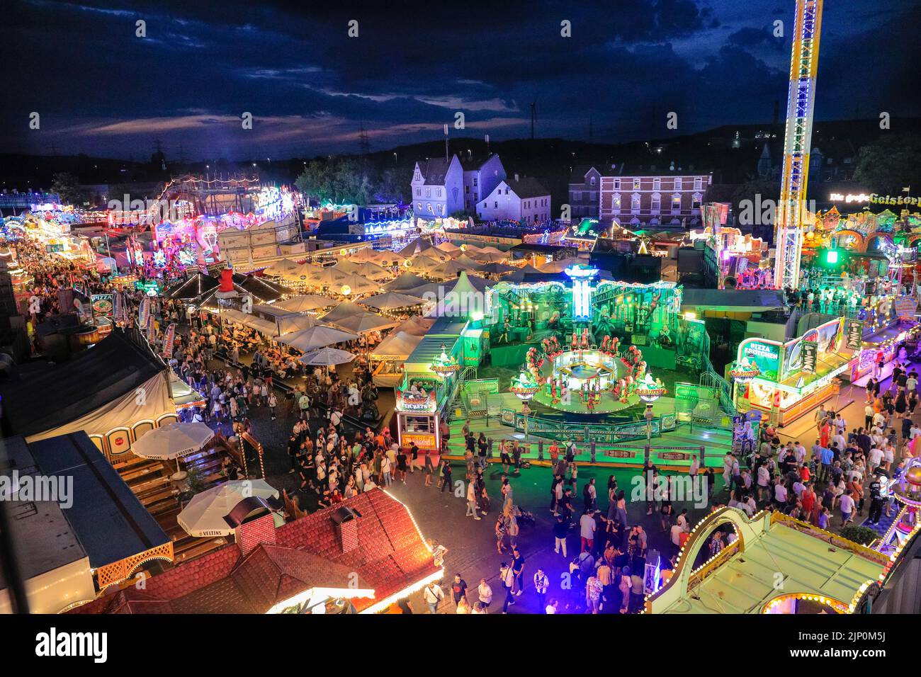 Herne, NRW, Germany. 14th Aug, 2022. People scream and laugh on the illuminated, 85m high 'Hangover - The Tower' thrill ride. Cranger Kirmes, Germany's 3rd largest funfair with a tradition dating back to the middle ages, has returned to pre-pandemic visitor numbers with more than 3.9m attending in hot, sunny weather, enjoying the rides, rollercoasters, beer halls, food and drink. The funfair concluded tonight with fireworks over the nearby Rhine-Herne Canal. Credit: Imageplotter/Alamy Live News Stock Photo