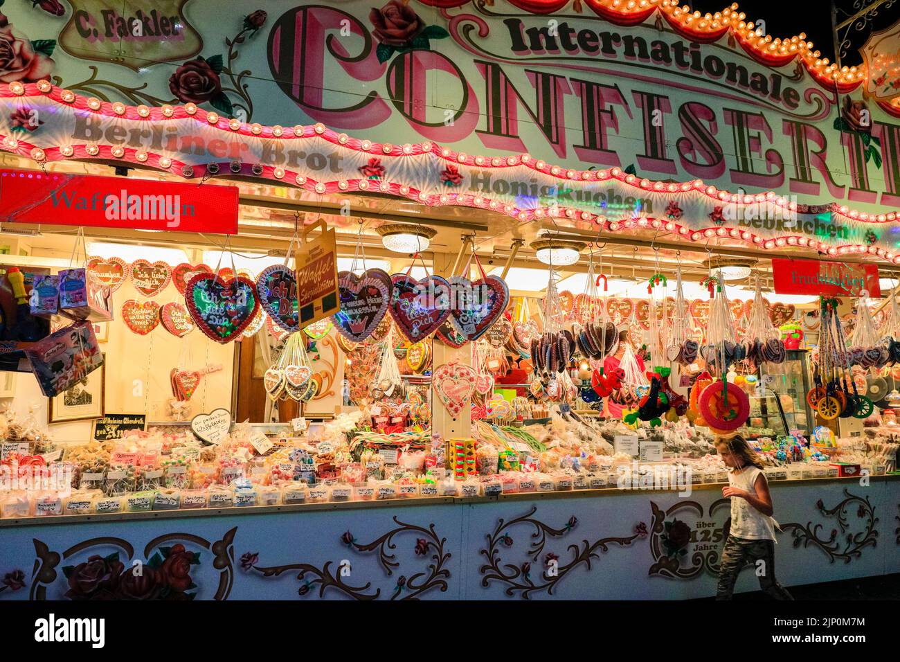 Herne, NRW, Germany. 14th Aug, 2022. The sweets stalls are brimming with treats that are hard to resist to the younger visitors. Cranger Kirmes, Germany's 3rd largest funfair with a tradition dating back to the middle ages, has returned to pre-pandemic visitor numbers with more than 3.9m attending in hot, sunny weather, enjoying the rides, rollercoasters, beer halls, food and drink. The funfair concluded tonight with fireworks over the nearby Rhine-Herne Canal. Credit: Imageplotter/Alamy Live News Stock Photo