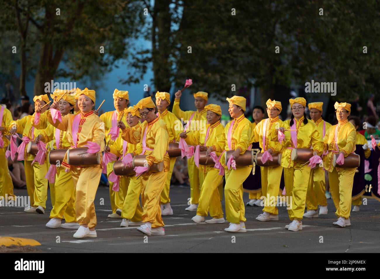 Falun Dafa practitioners’ waist-drum team performs during the Seafair Torchlight Parade in Seattle on Saturday, July 30, 2022. Stock Photo