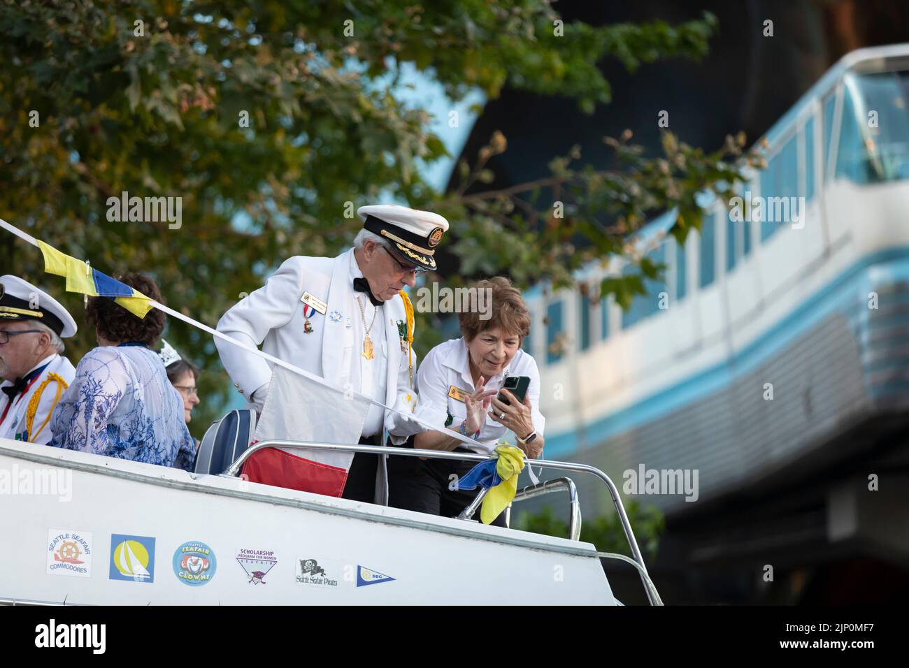 Members of the Seafair Commodores take photos as the Seattle Center
