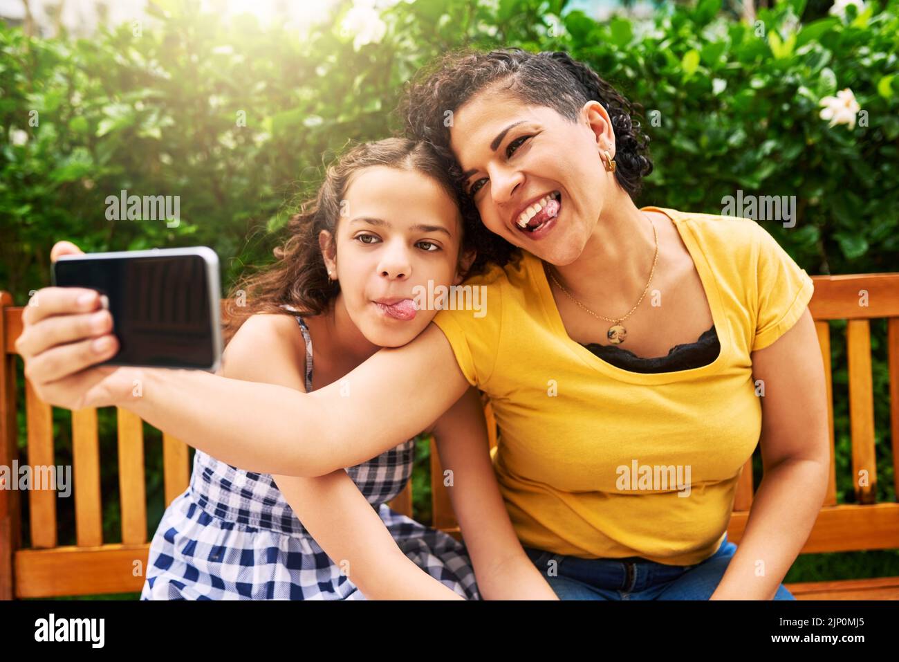 Be as goofy as you can. a young mother and her daughter taking selfies