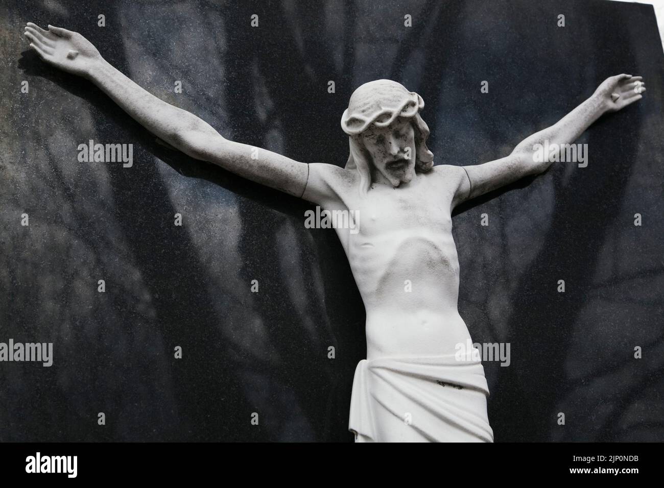 Religious statue on memorial monument in a cemetery Stock Photo Alamy