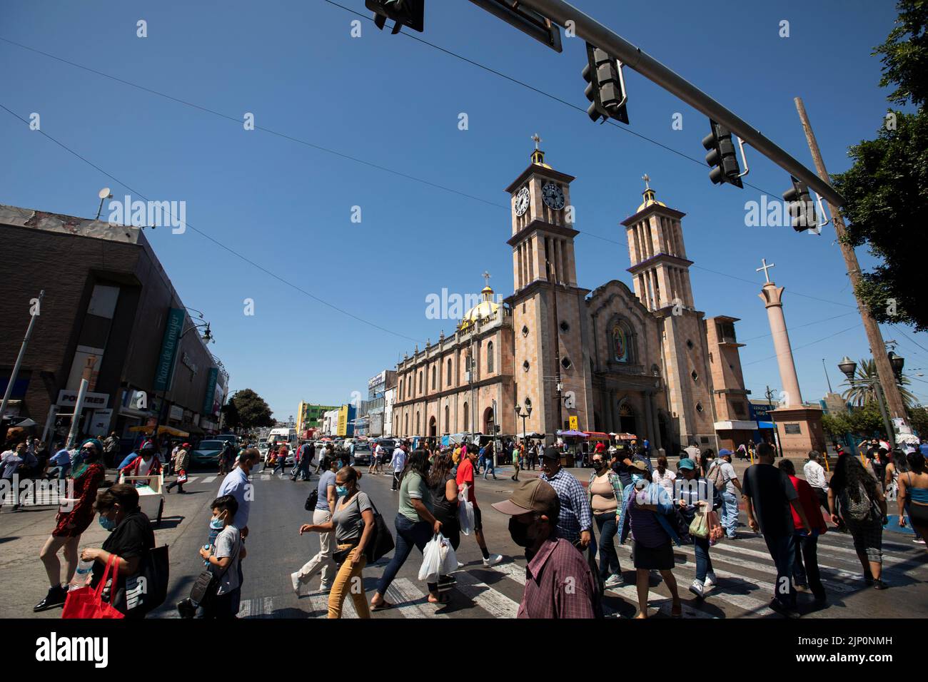 Tijuana, Baja California, Mexico - September 11, 2021: Crowds of people cross a street in downtown Tijuana. Stock Photo