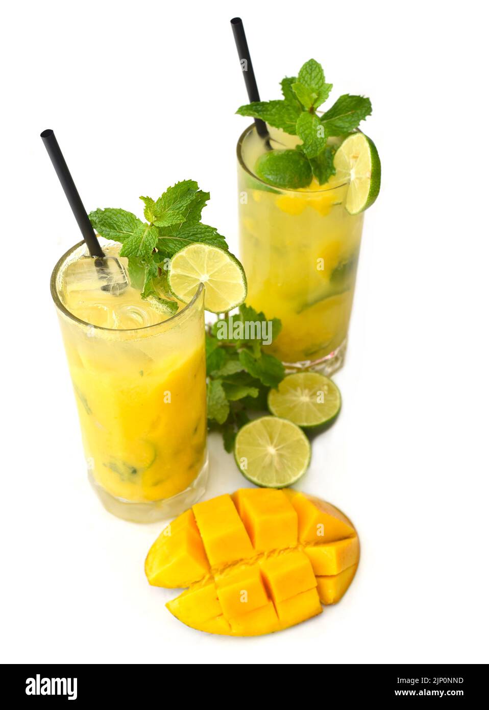 Mango mojito in highball glasses with sliced mango isolated on white