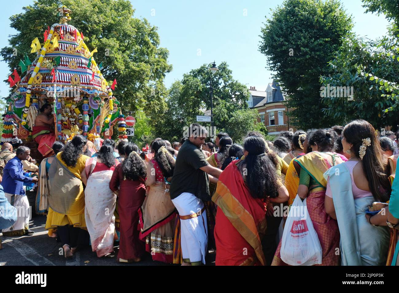 London, UK, 14th August, 2022. The annual Hindu Chariot Festival organised by the Tamil Kanaga Thurkkai Amman Temple returns after three years and is held to mark Lord Murguran's victory against a demon named Soorapadem, who was killed with a spear. The event attracts thousands of attendees from the UK and all over Europe, where religious rituals take place on a procession with chariots close to the temple. Credit: Eleventh Hour Photography/Alamy Live News Stock Photo