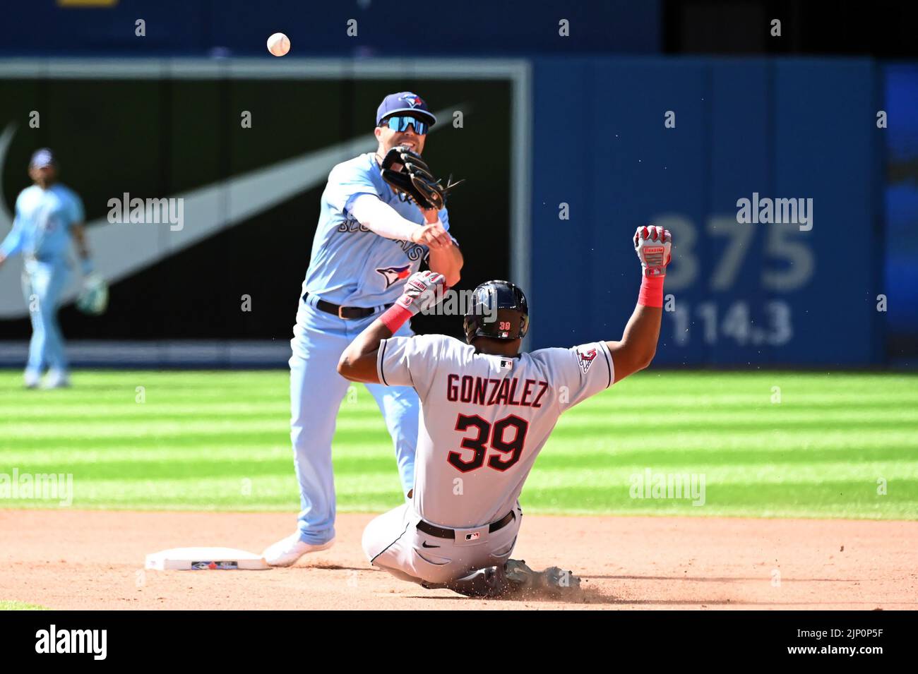Toronto Blue Jays‚Äô second baseman Whitt Merrifield, left, throws to