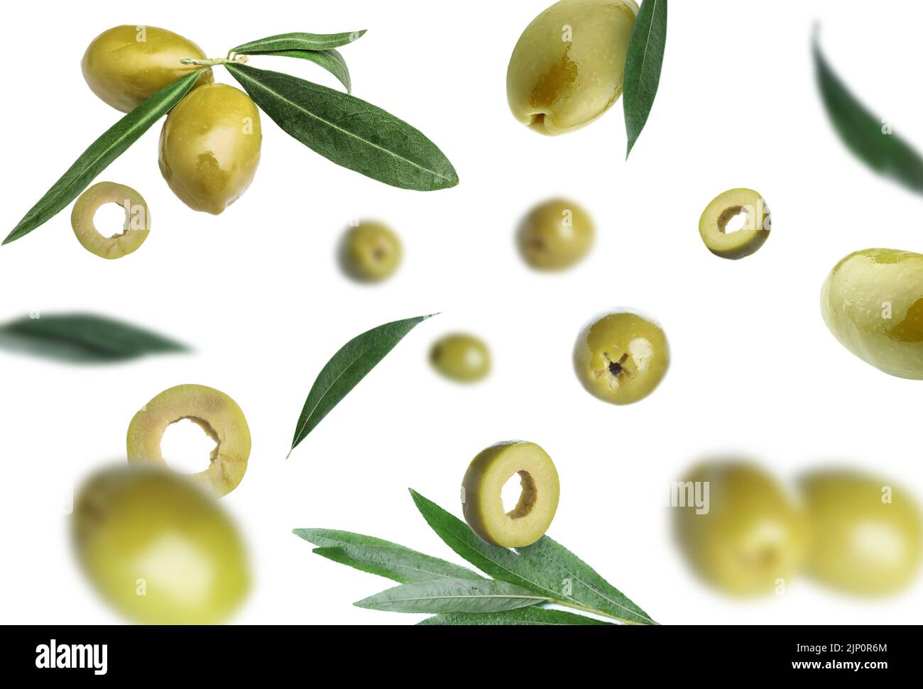 Falling green olives on white background Stock Photo