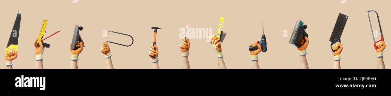 Many hands with different carpenter's tools on beige background Stock Photo