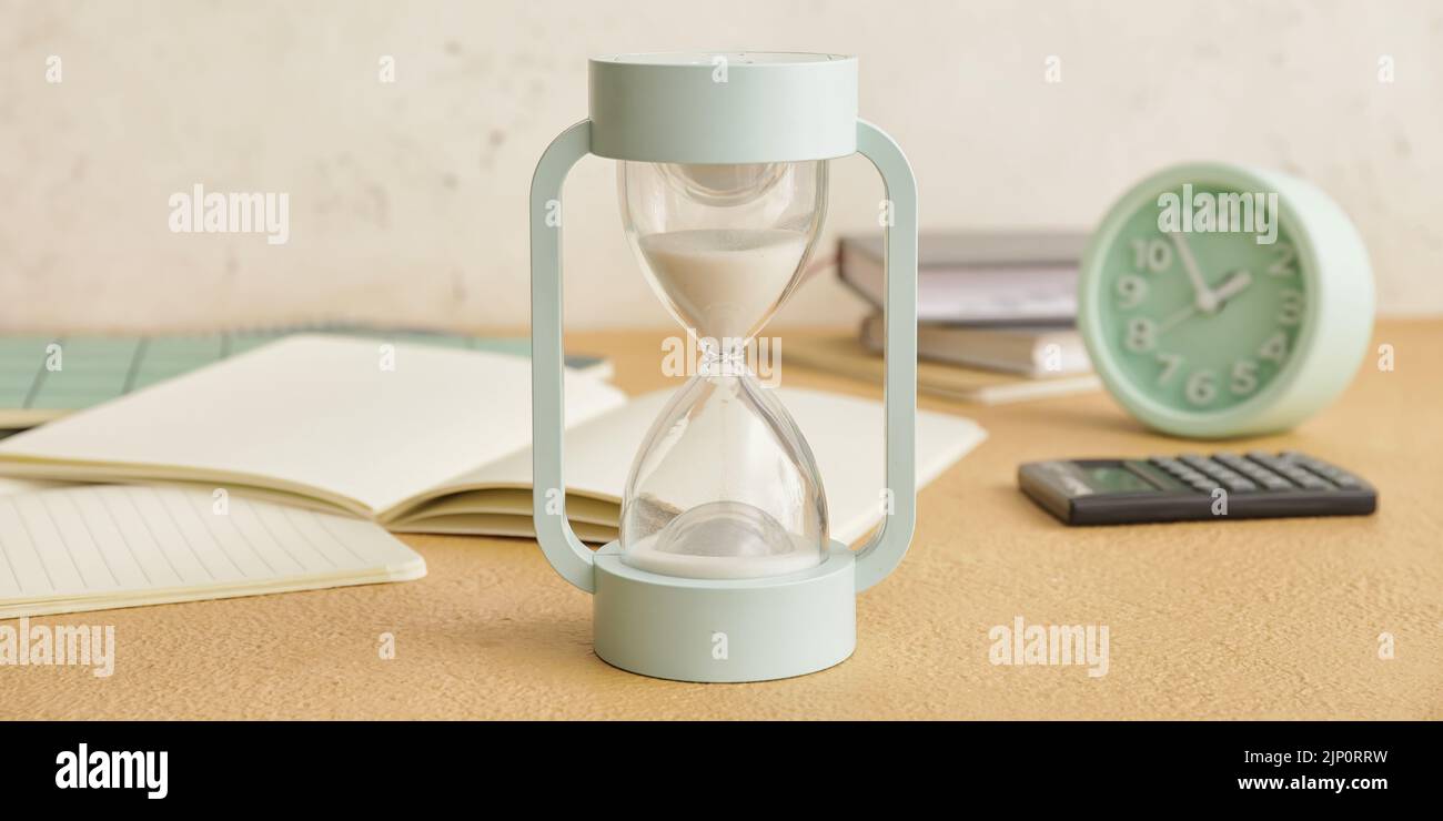 Hourglass on table. Time management concept Stock Photo - Alamy