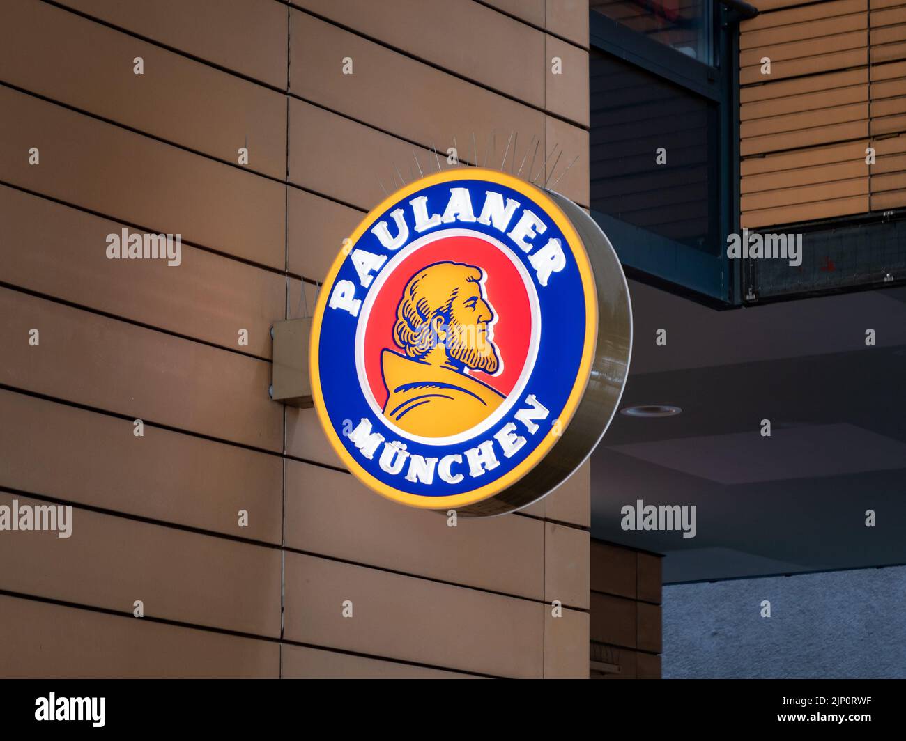 Paulaner Brewery symbol on a building exterior in the city. Facade