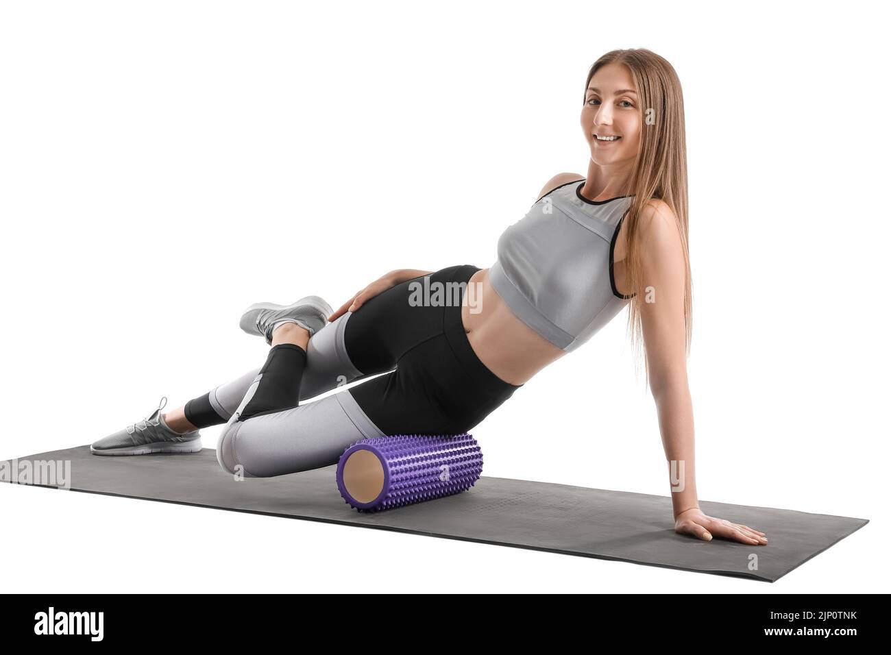 Young woman training with foam roller on white background Stock Photo ...