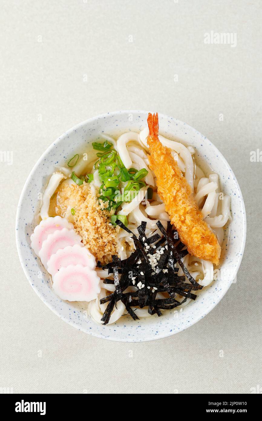 Top View Japanese Udon with Seafood Broth, Crispy Tempura, Green Onion