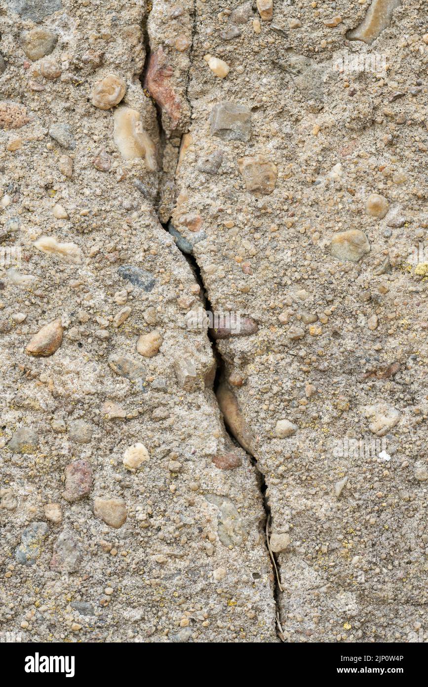Close up of cracks in a dilapidated concrete wall on a building Stock Photo