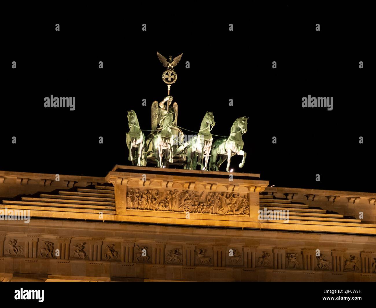 Quadriga on the Brandenburg Gate at night. The sculpture was designed by Johann Gottfried Schadow. The German culture in the capital city Berlin. Stock Photo