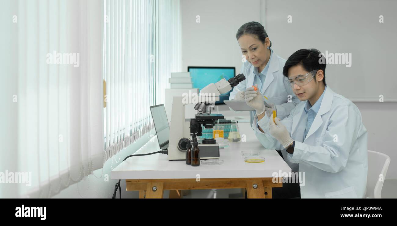 Group of science researchers working with test tube medical science ...