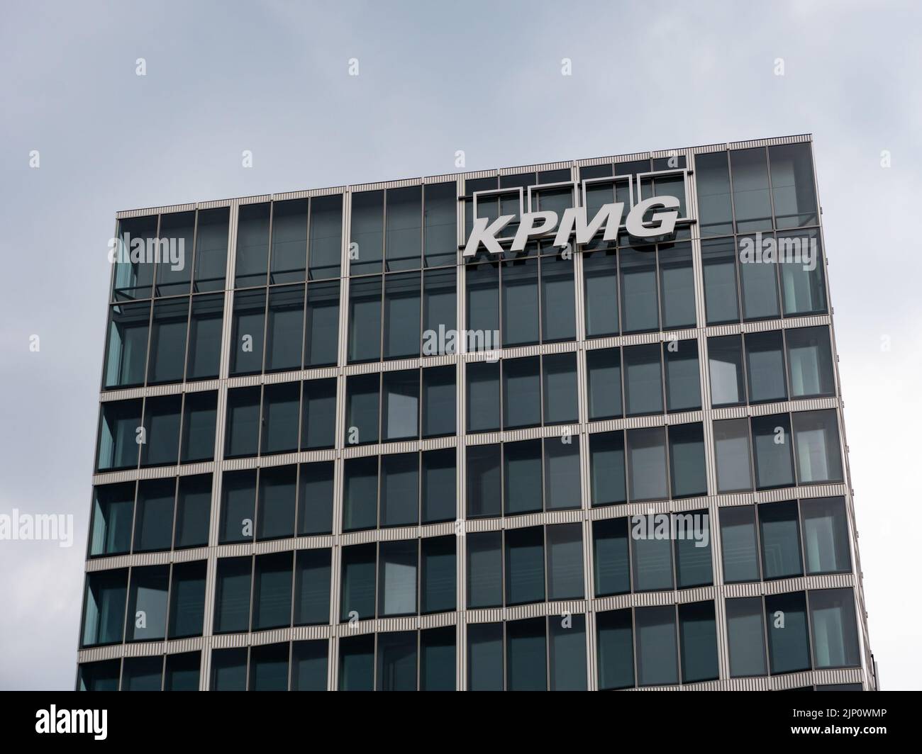 KPMG logo on a tall office building next to the main station. One of the Big Four accounting organisations. Modern urban architecture in the city. Stock Photo