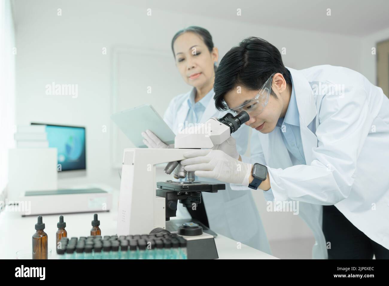 Group of science researchers working with test tube medical science ...
