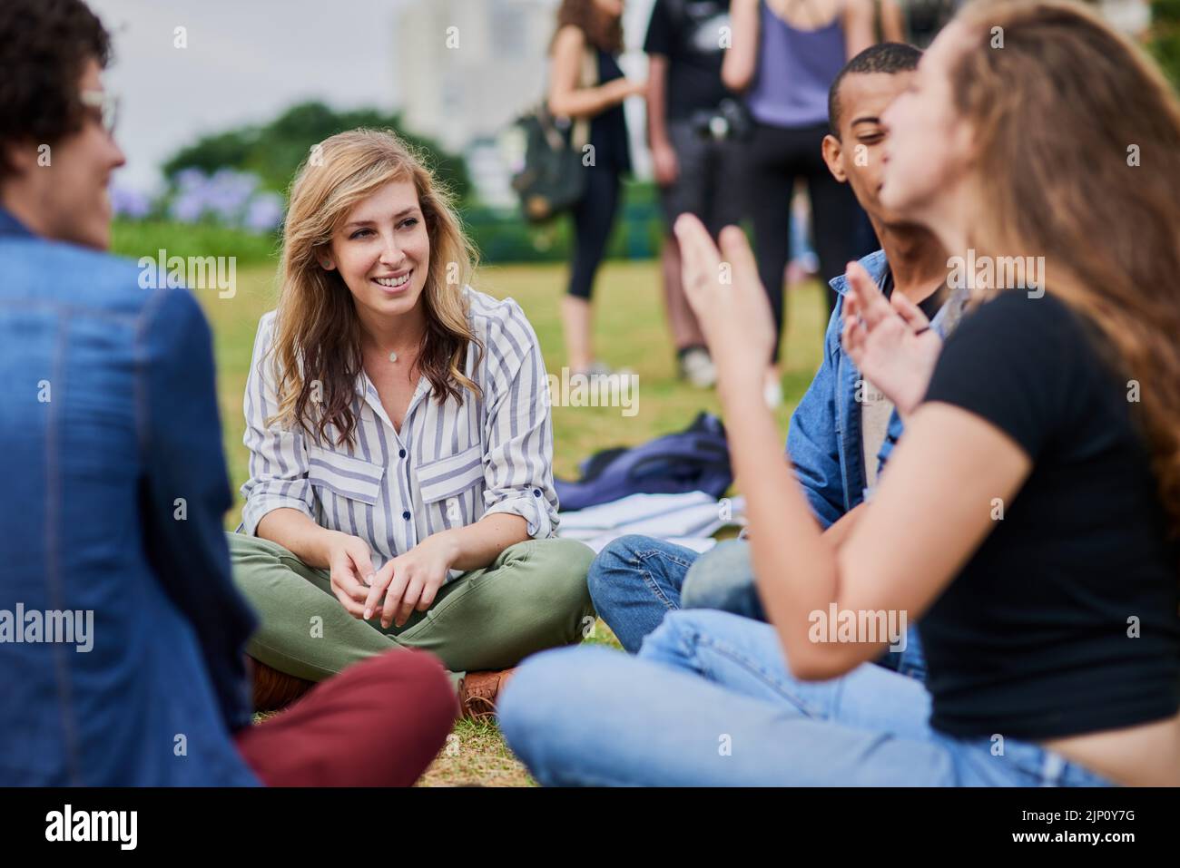 Chatting about life. a group of young students studying together while ...