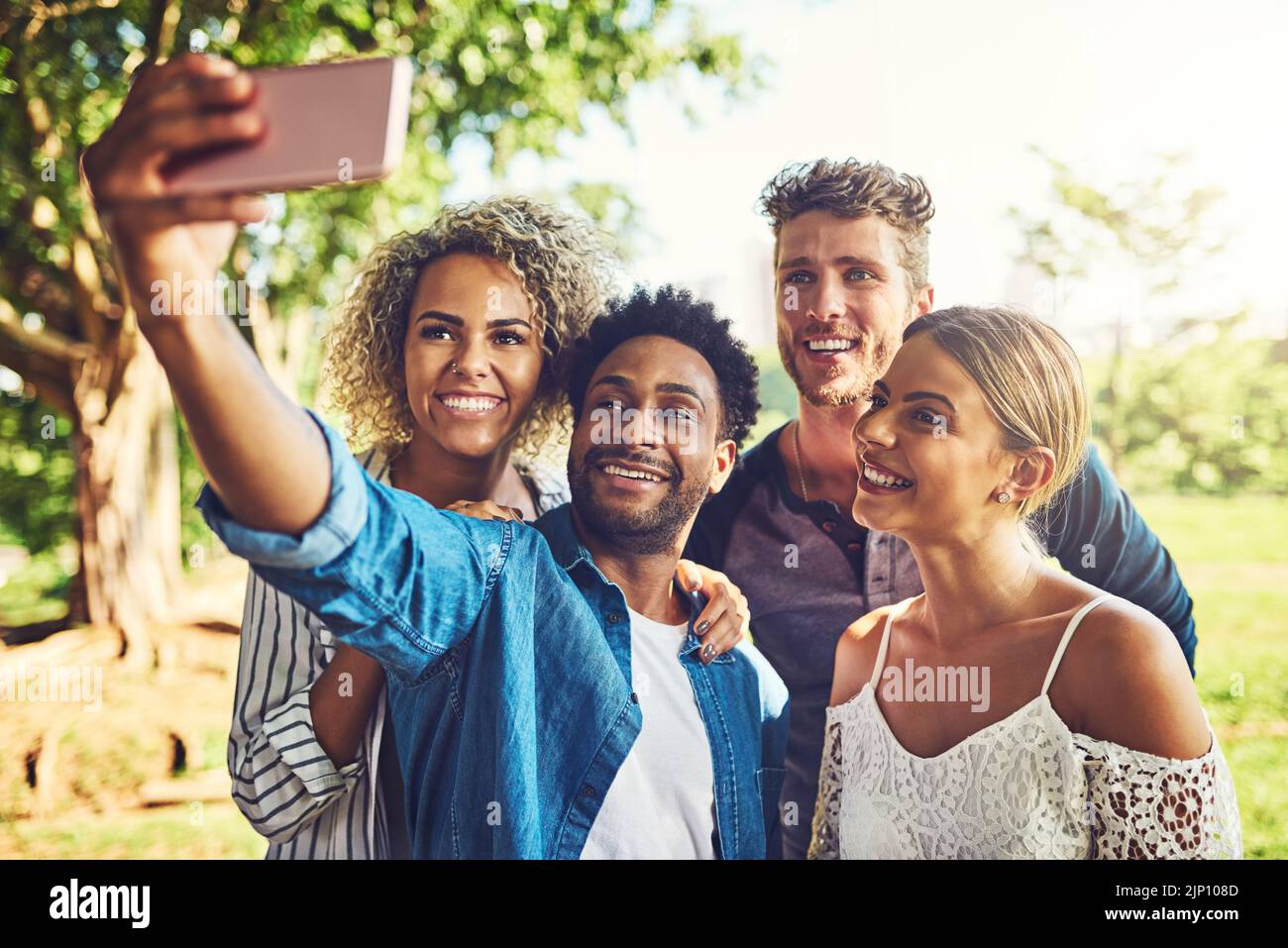 Our double date is going great. two happy young couples taking a selfie together outdoors. Stock Photo