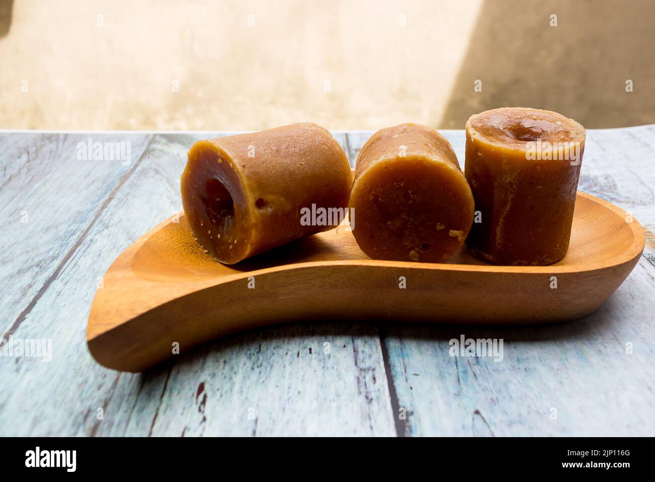 selective focus of brown sugar cubes in wooden tray Stock Photo