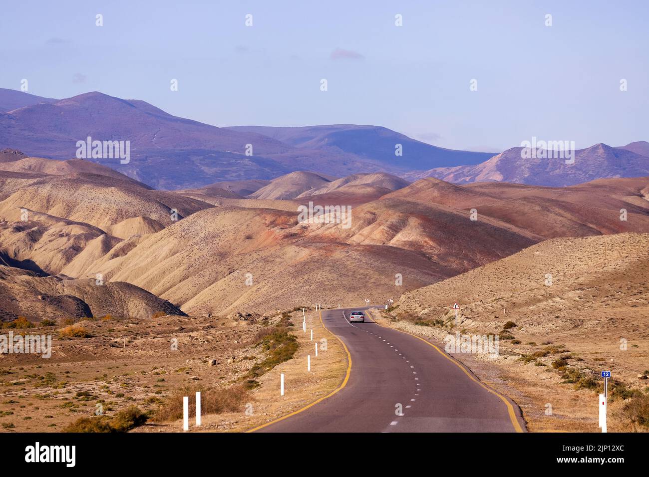 The car leaving in the distance on the road. Khizi region. Azerbaijan. Stock Photo