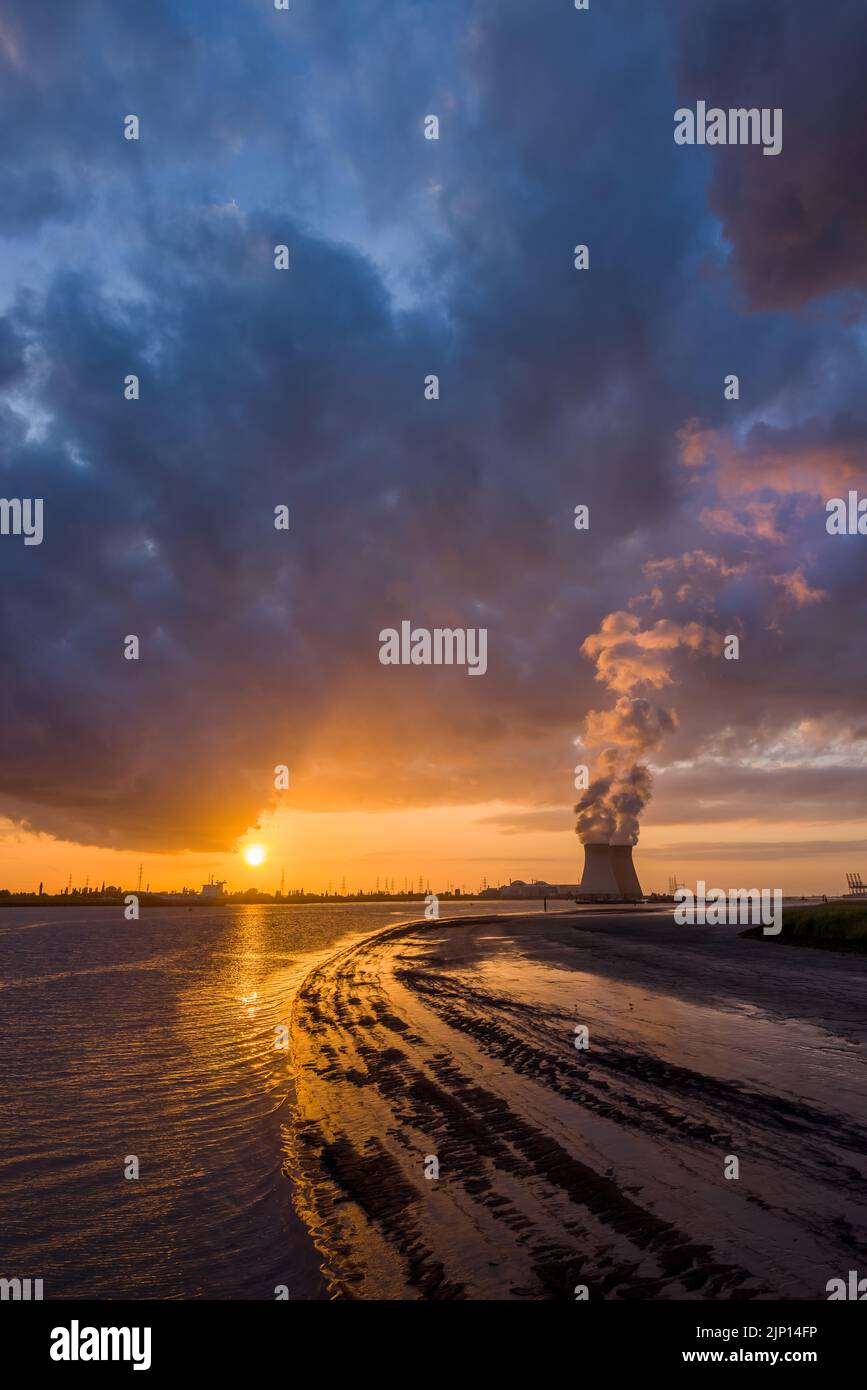 Colorful sunset over Antwerp world port in Belgium, with a view on the towers of the nuclear plant Stock Photo
