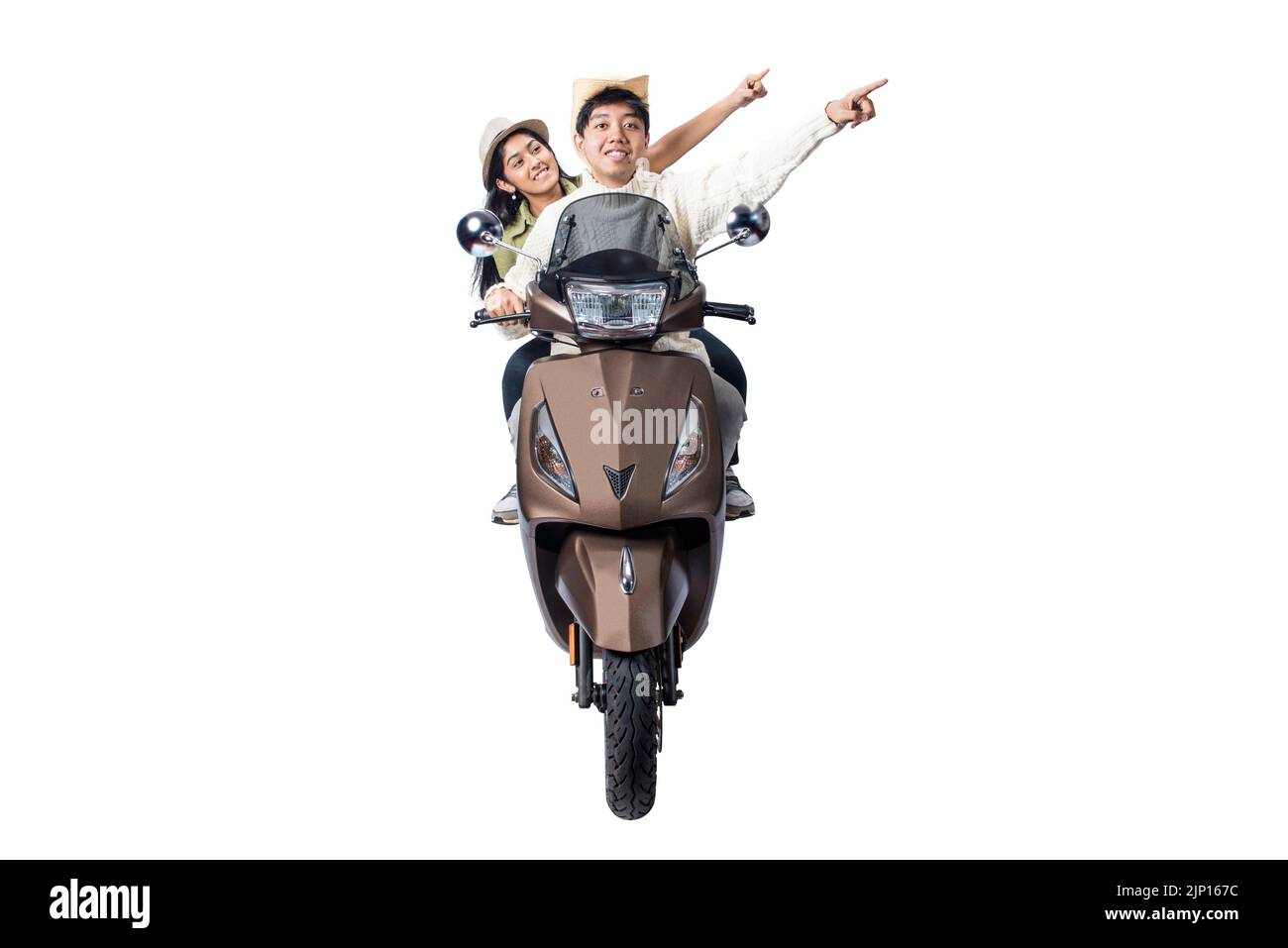 An Asian couple with a hat is sitting on a scooter and pointing something isolated over white background Stock Photo