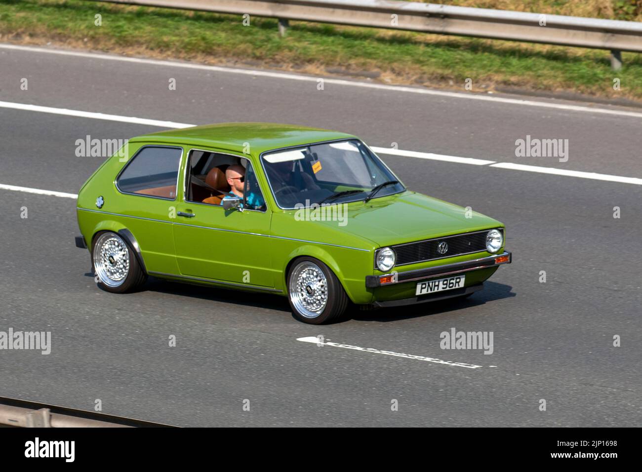 1976 70s seventies green restored VW Volkswagen Golf L 2792 cc; travelling on the M6 Motorway, Manchester, UK Stock Photo