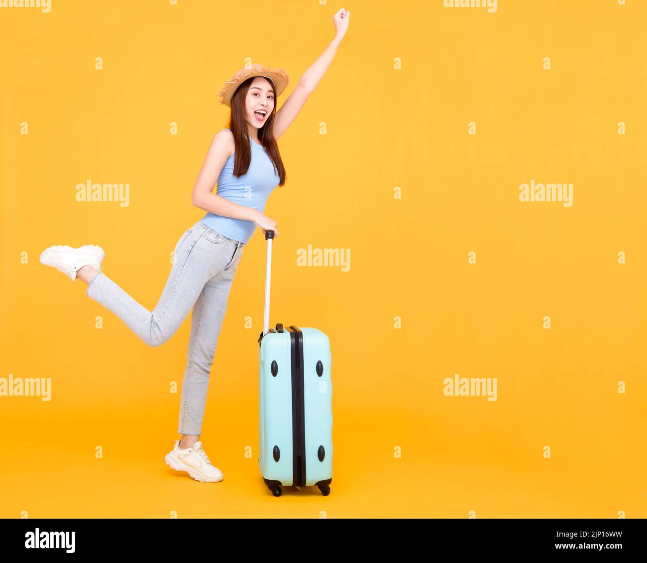 Happy young woman with  luggage isolated on yellow background ,summer,travel concept. Stock Photo