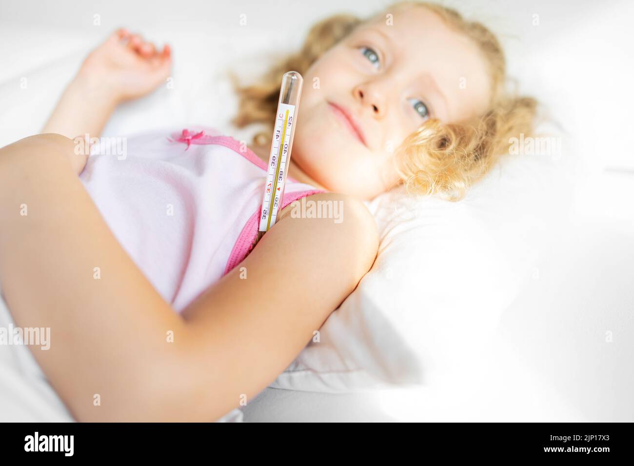 The child has a high temperature. Measurement with a mercury