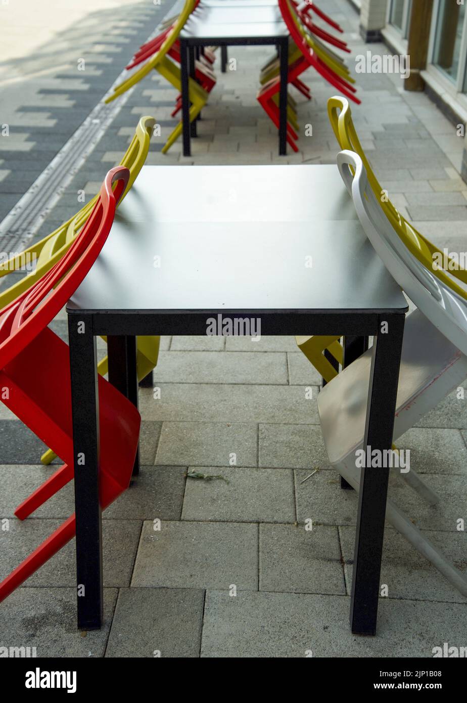 Outdoor dining tables and chairs in city street Stock Photo Alamy