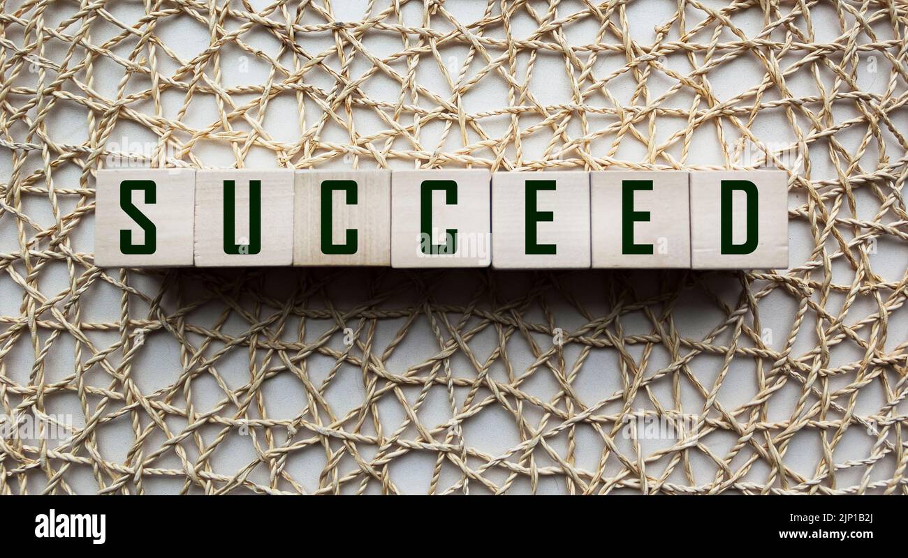 The word succeed on the block of wood. Stock Photo